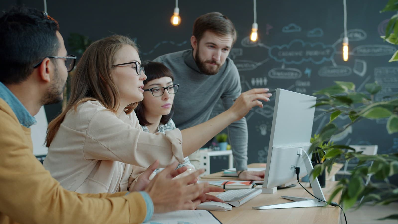 Small team being walked through a new setup on an office computer