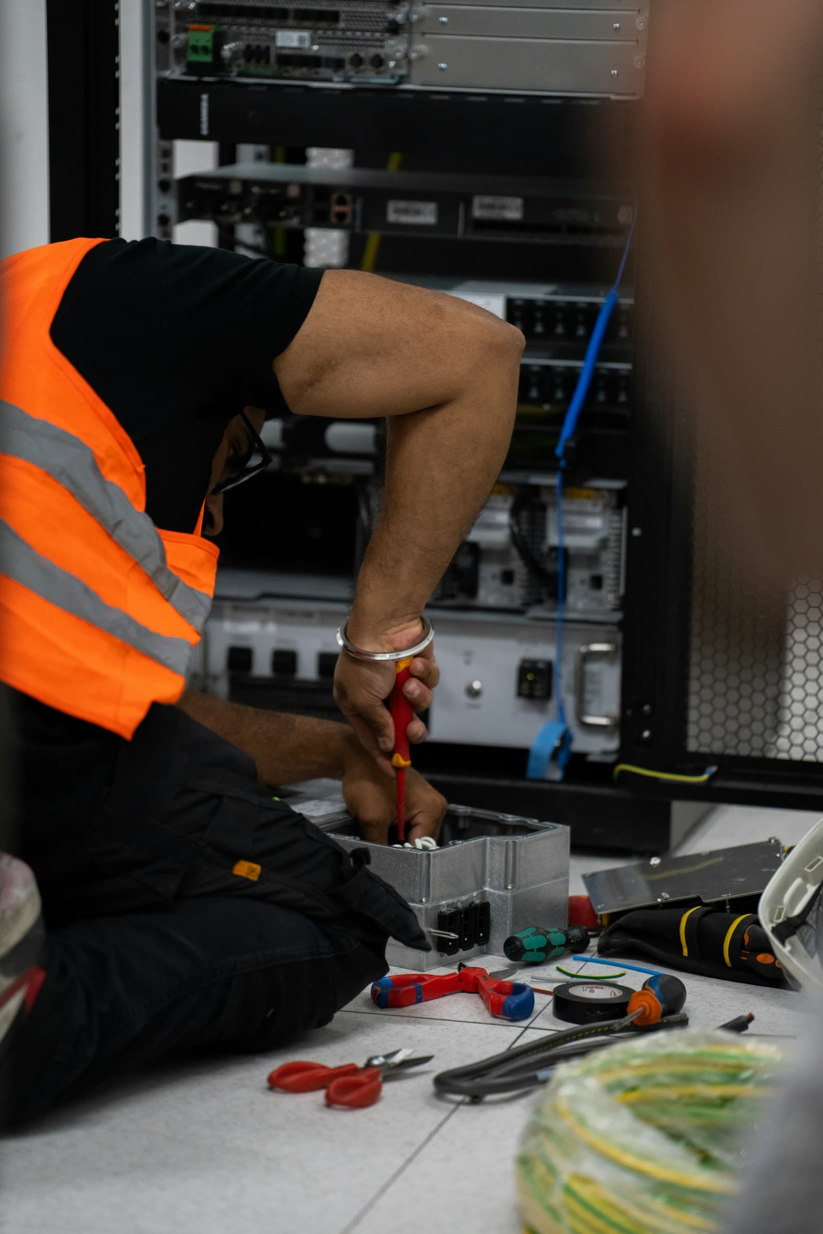 Technician installing network equipment in a rack